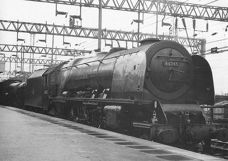 Ex-LMS 4-6-2 Coronation class No 46245 is seen passing through platform 5 at the head of an up express parcels and milk train