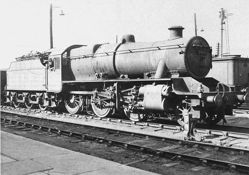 LMS 5MT 2-6-0 No 2977 is seen standing held by signals opposite Nuneaton station's platform 5 during shunting of the yard