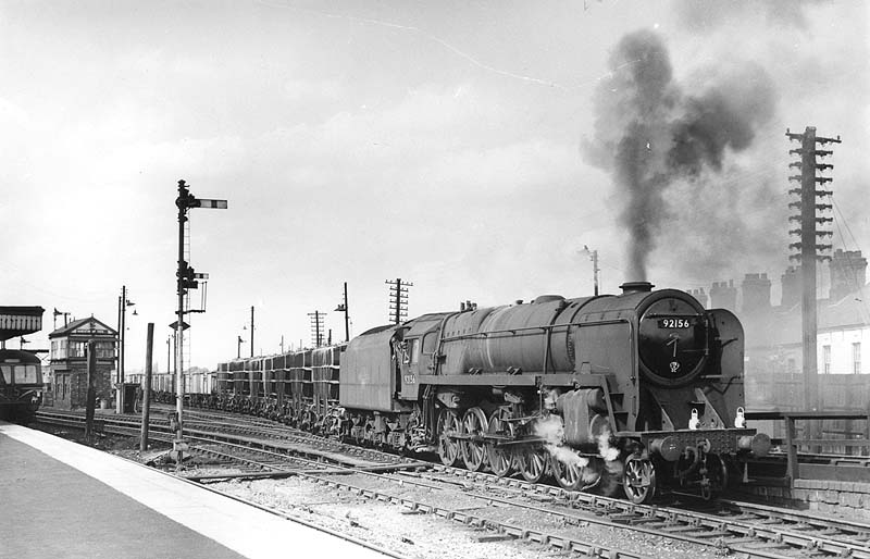 British Railways Standard Class 9F No 92156 is seen at the head of a mineral train leaving the up marshalling yard