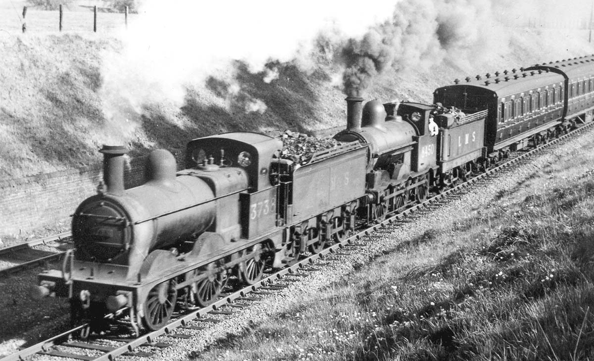 Close up of ex-MR 2F 0-6-0 No 3738 and ex-LNWR 2F 0-6-0 'Cauliflower' No 8450 showing both locomotives working hard on the bank