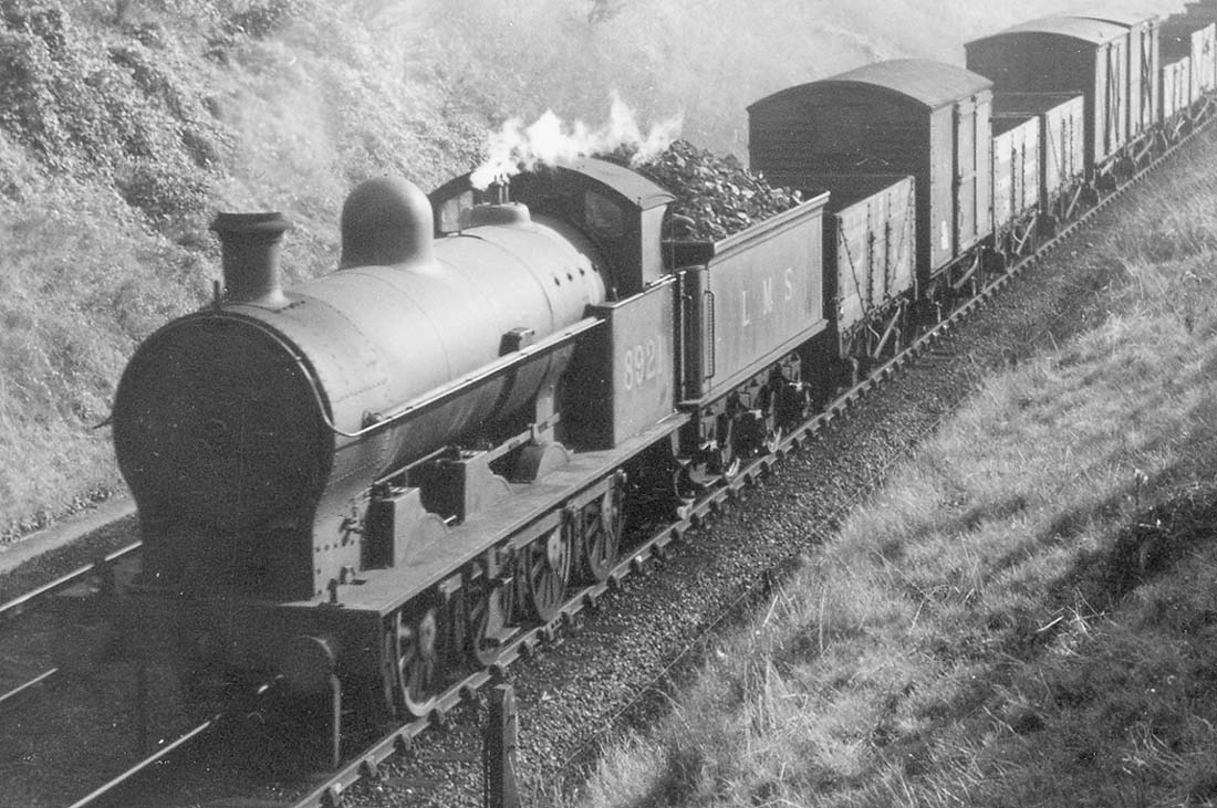 Close up showing ex-LNWR 7F 0-8-0 'G2A' No 8921 is still carrying its original round top firebox whilst the tender is loaded to the gunnels with coal