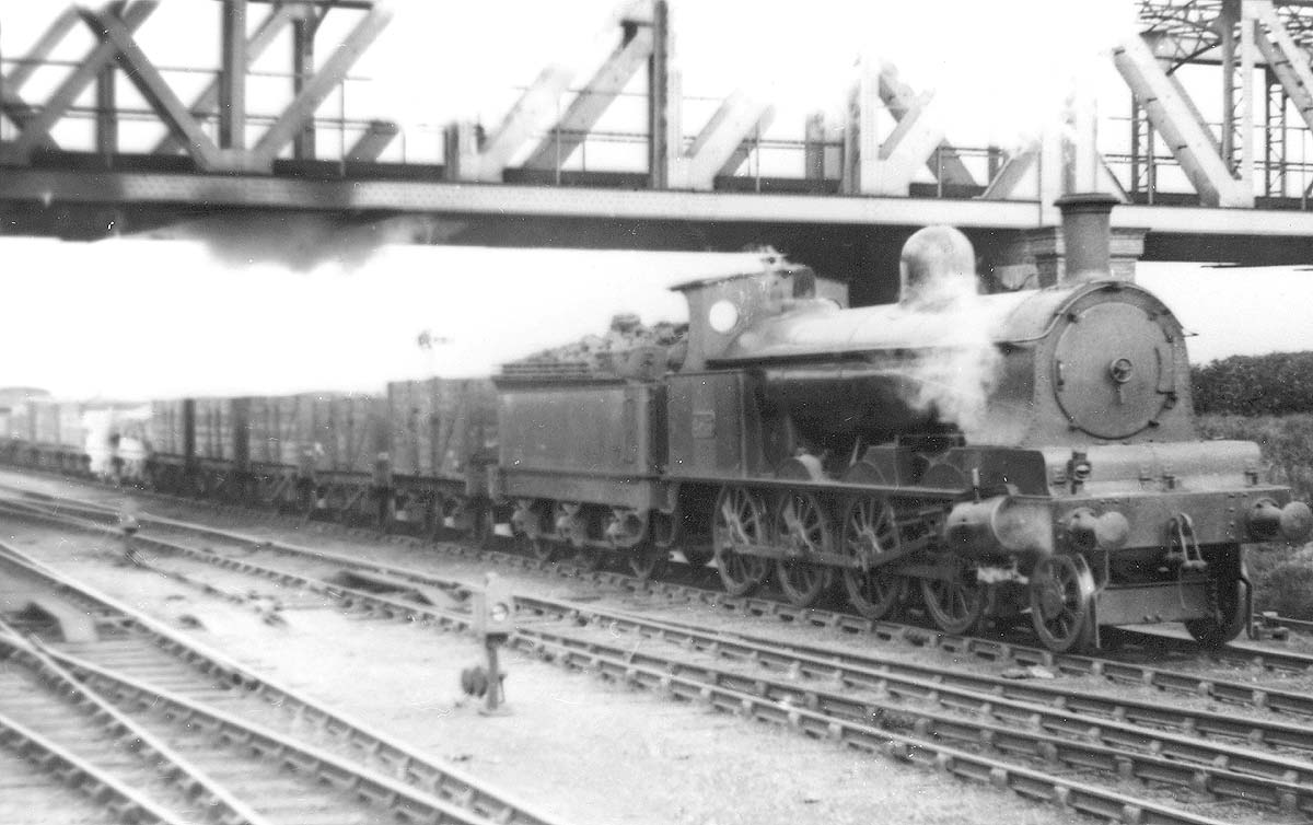 LNWR 2-8-0 E class No 2563 is seen passing under the GC Birdcage bridge whilst at the head of an up goods train circa 1919-23
