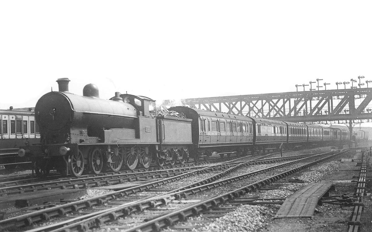An unidentified LNWR 4-6-0 Prince of Wales class locomotive is seen entering the station on a down express as it passes under the GC bridge circa 1920-22