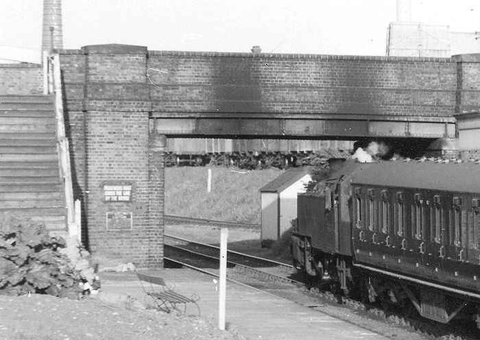 Close up of the Weeden end of the up platform with the steps to the road bridge on the left and the ex-LMS 2MT Ivatt 2-6-2T at the rear of the train on the right