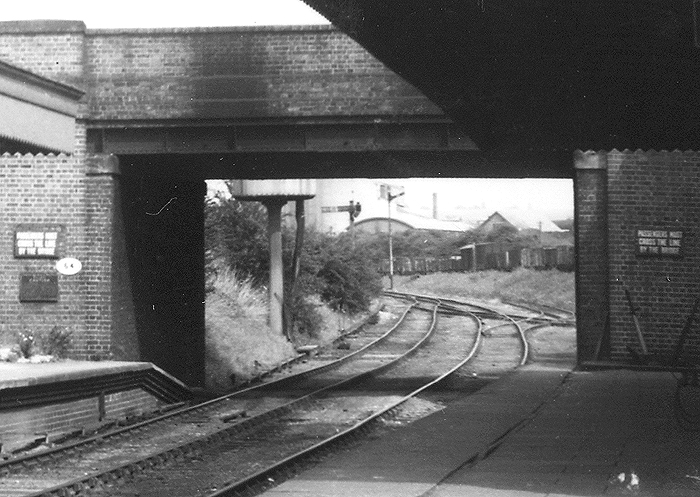 Close up showing the parachute water tank situated on the up line beyond the bridge and the sidings to the cement works on the right