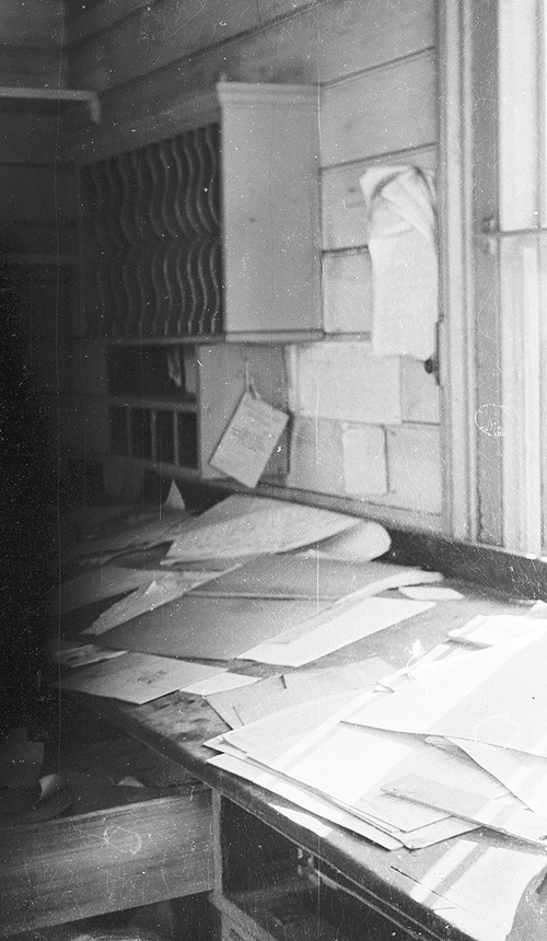 View inside the booking office at Southam & Long Itchington station showing the fixed sloping desk and the pigeon holes for paperwork