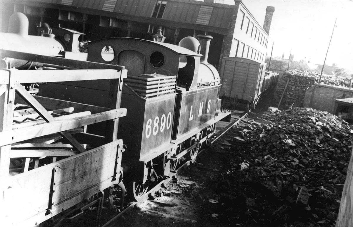 Ex-LNWR 2P 0-6-2T 'Watford Tank' No 6890 stands in front of the engineering department's wagon adjacent to Milverton's coal stacks