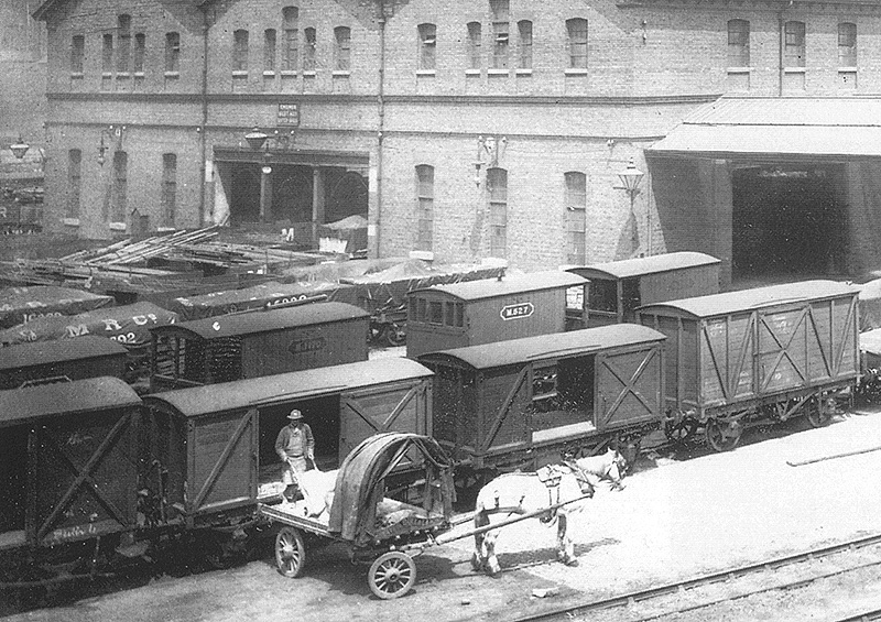 Close up showing one of the Midland Railways' four-wheel non-ventilated covered vans being unloaded