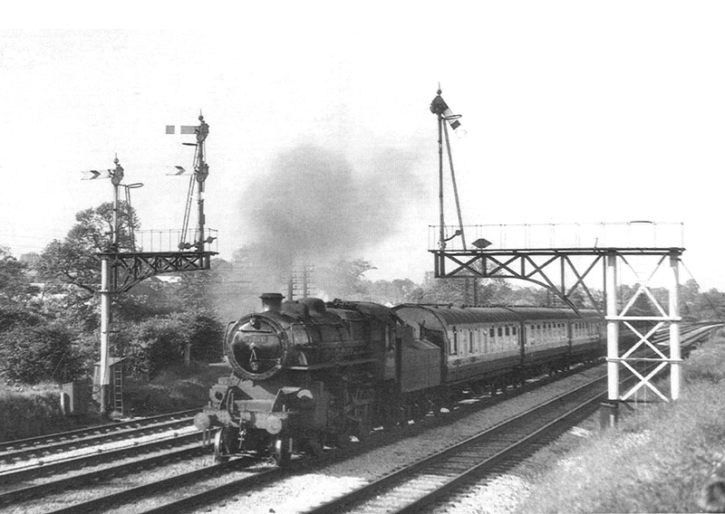 British Railways built 2-6-0 4MT No 43036 is seen at the head of a down ordinary passenger service on 18th June 1953