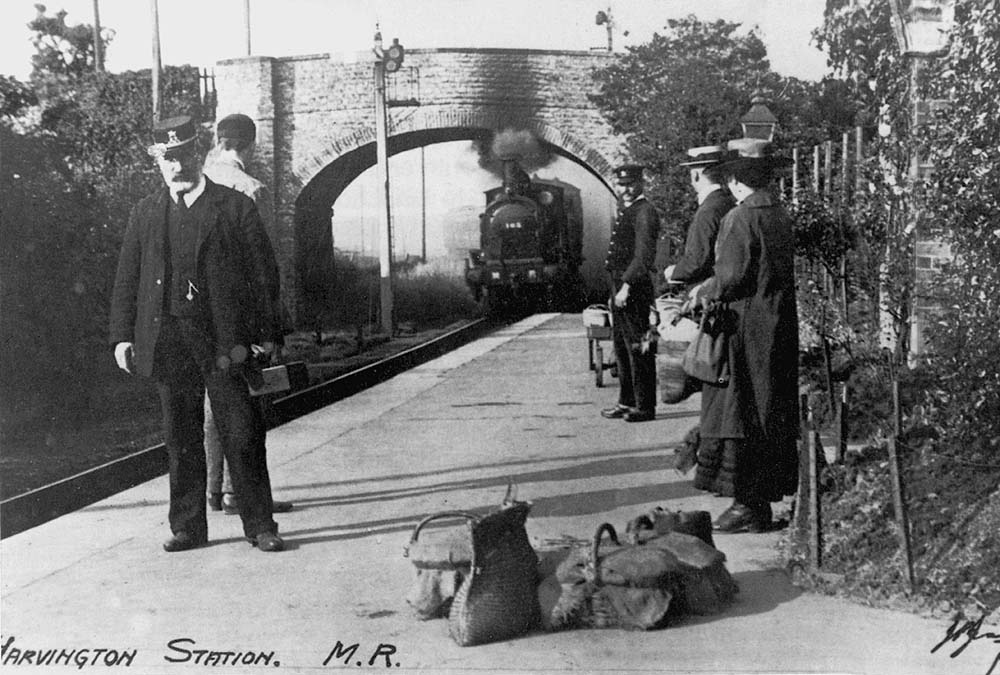 MR 1P 2-4-0 No 165 is seen entering the station with a reasonably heavy train with passengers ready to embark