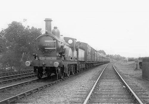 MR 2-4-0 No 279 with several vans behind the tender on a passenger train near Kings Norton