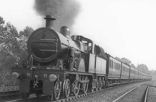 MR 4-4-0 No 768 which has been converted for oil firing is at the head of a down express train south of Kings Norton