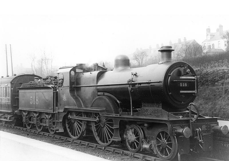 MR 4-4-0 No 518 is seen standing in the station at the head of an up train at the head of a local passenger service