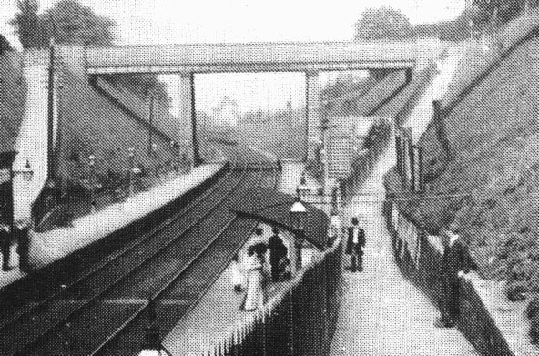 Close up showing the public footpath and on the down platform the unusual passenger shelter