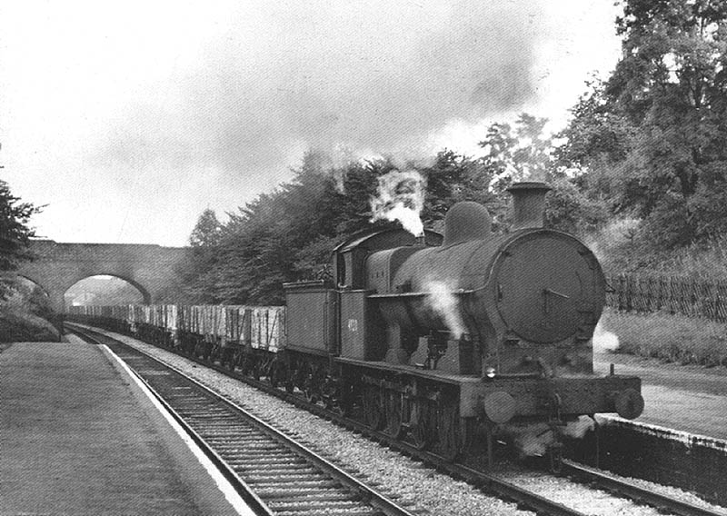 Ex-LNWR 7F G2a 0-8-0 No 49210 trundles through Penns station on a north bound freight on 5th September 1959
