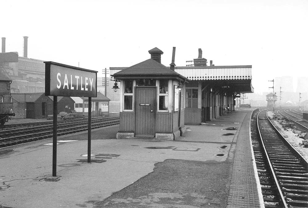 Looking towards Water Orton along Saltley station's down platform with Saltley Sidings Signal Box and adjacent sidings in the distance