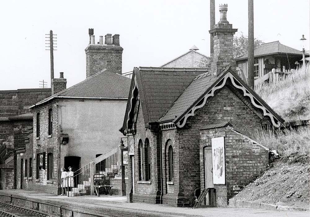 Close up showing the structures on the down platform with at least three different brick buildings evident