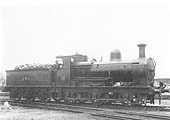 SMJ 0-6-0 No 18 stands outside Stratford on Avon shed with the driver posed for the camera