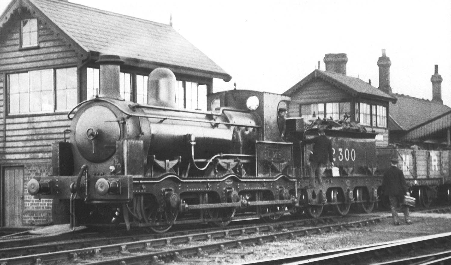 Ex-E&WJR 0-6-0 No 2300 stands resplendent in its new LMS livery as the locomotive crew change over on 8th April 1924