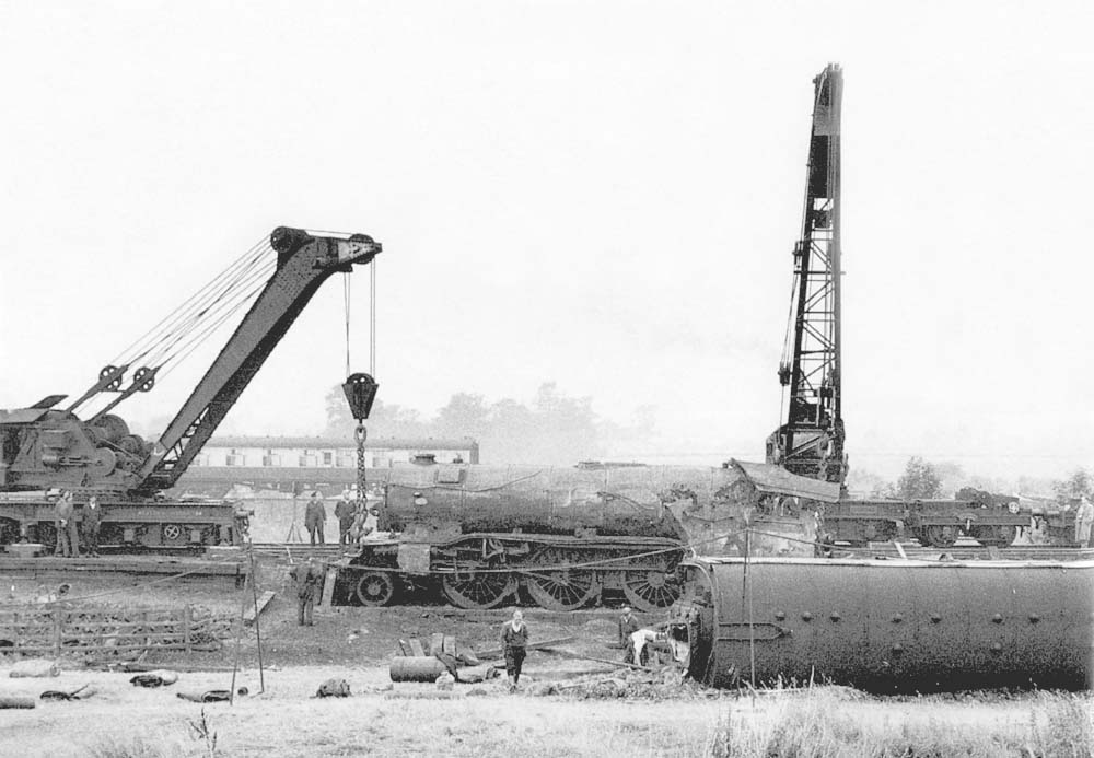 View of ex-LNER 2-6-2 Class V2 No 60828 being lifted by two railway cranes back on to the track