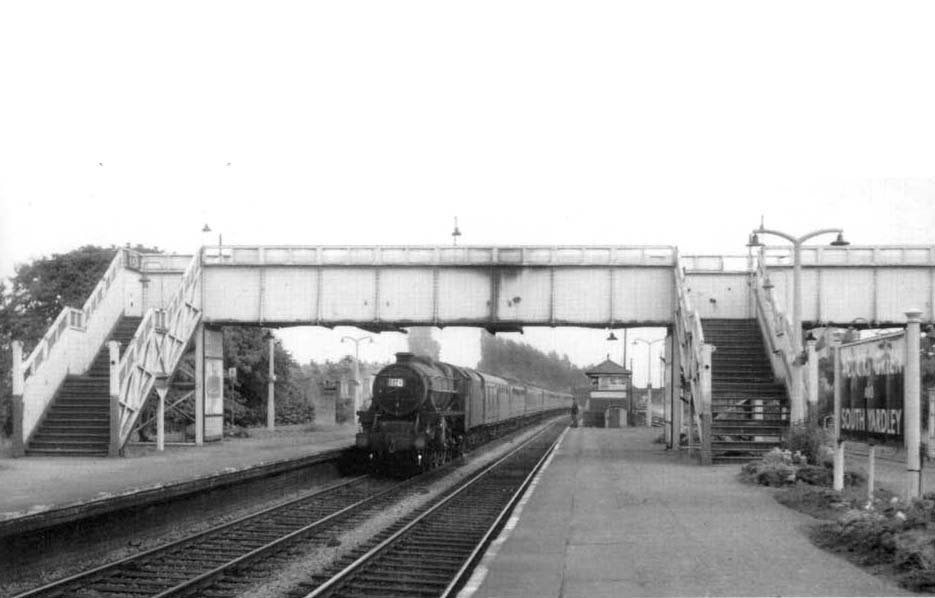 An unidentified ex-LMS 4-6-0 'Black Five' is seen at the head of a down express service eminating from the south