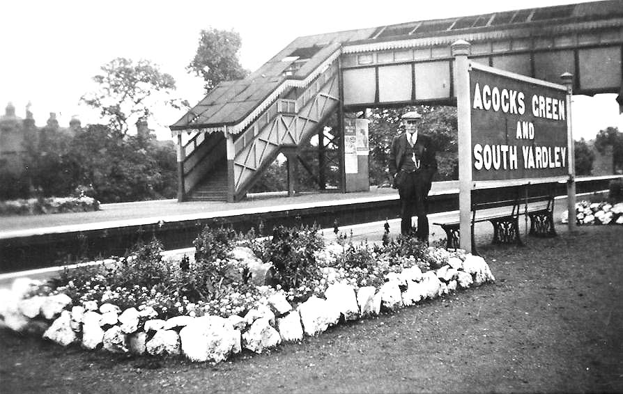 Looking across from the relief island platform to the main island platform showing the floral display beds with the original covered footbridge in the background