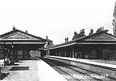 View of Acocks Green station looking towards Birmingham along relief platform 3 and staff posed on the down main platform