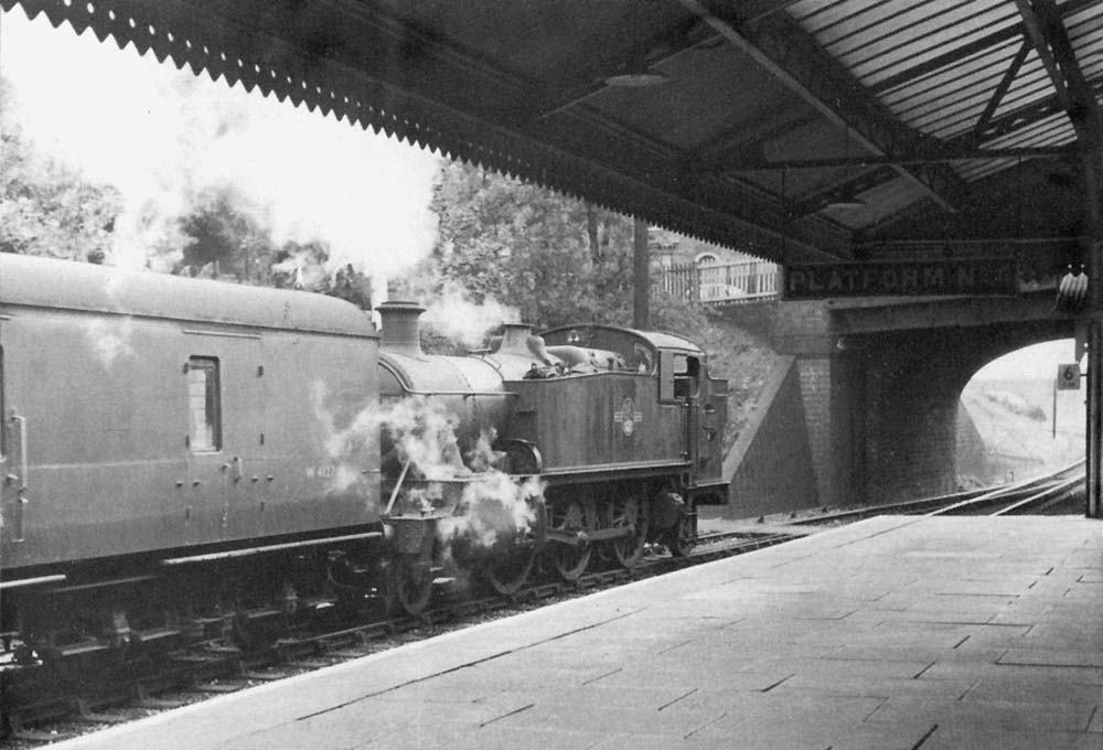 Ex-GWR 2-6-2T 61xx Class No 6144 restarts from the down loop line with empty local carriage stock stock in July 1961