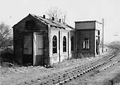 View of the derelict shed adjacent to Alcester Junction with the wooden doors and water tank still retaining the distinctive GWR painting policy
