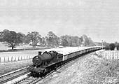Ex-GWR 2-8-0 28xx Class No 2859 passes Bearley distant signal with an iron ore train for South Wales in 1956