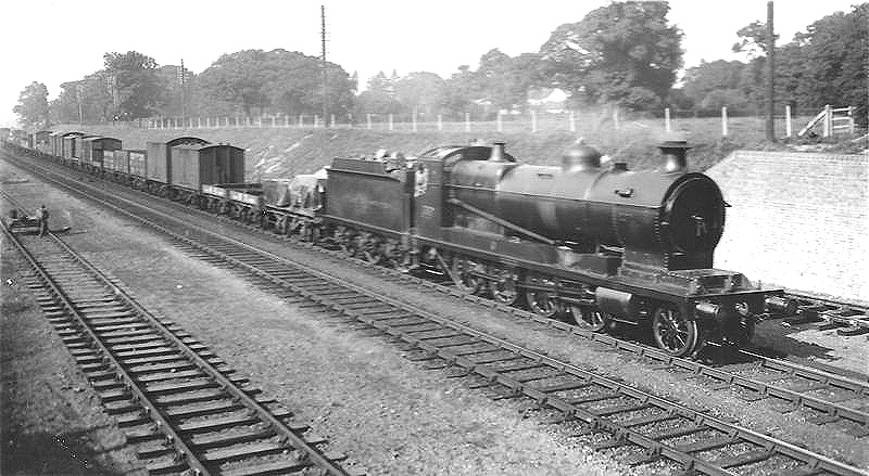 GWR 2-8-0 30xx Class No 3001 steams past Bentley Heath with a southbound freight train in the late afternoon sunshine during 1933