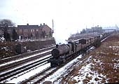 An unidentified ex-GWR 2-8-0 locomotive with a northbound class E express freight passes on the down relief line