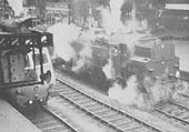 British Railways 2-6-4T Standard Class 4 No 80072 is seen with an unidentified ex-GWR Manor class locomotive standing on the down through line in the 1960s