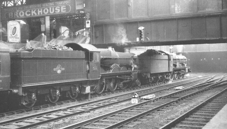 A pair of ex-GWR 4-6-0 Castle class locomotives, No 5040 'Stokesay Castle and No 5049 'Earl of Plymouth' are seen standing under the footbridge