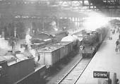 Ex-SR 4-6-2 West Country Class No 34094 is seen standing on the down through road whilst ex-LMS 2-8-0 8F No 48417 stands on Platform 7 on 27th April 1963