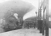 A pair of unknown GWR 4-2-2 'Achilles' class locomotives are seen at the head of a down express for Wolverhampton at the North end of Snow Hill