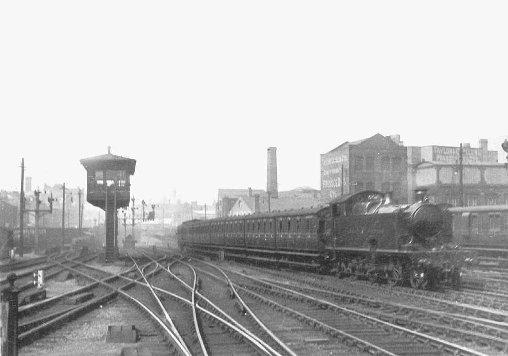 An unidentified GWR 2-6-2T 39xx class locomotive is seen passing Snow Hill's North Signal Box at the head of an up local passenger train