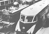 An unidentified GWR 0-6-0PT locomotive is seen passing an unknown GWR Railcar whilst at the head of an up freight working from Bordersley