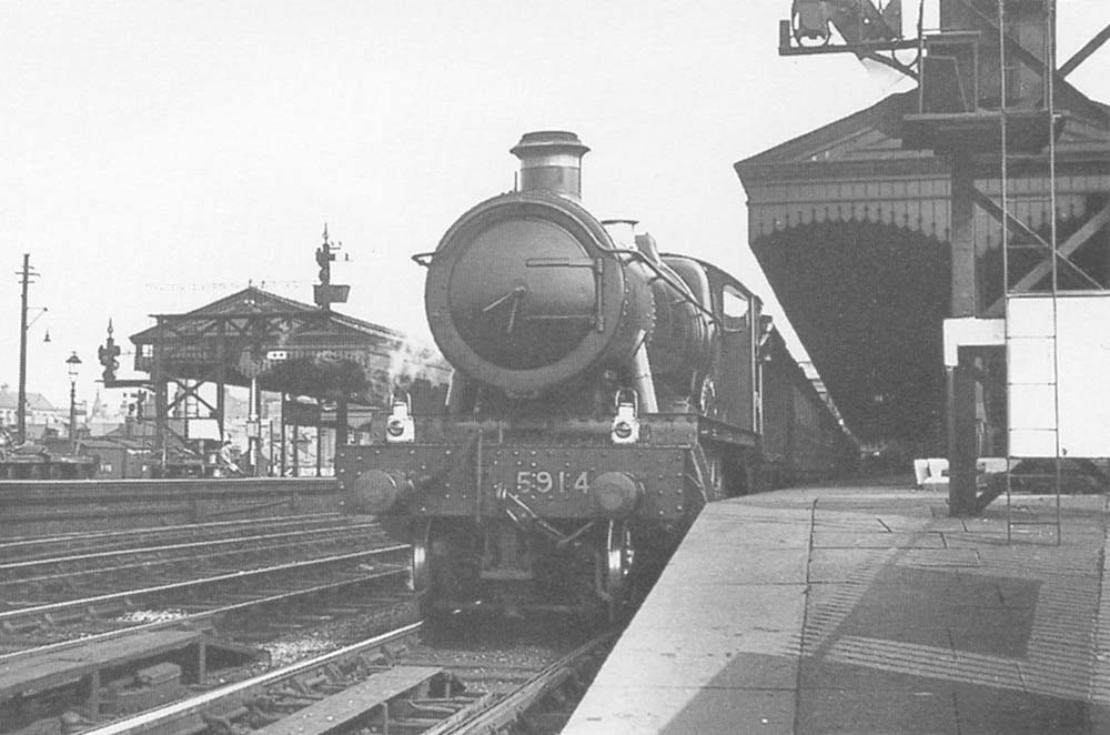 GWR 4-6-0 Hall class No 5914 'Ripon Hall' is seen standing at the head of a down express service to Wolverhampton on 5th June 1937