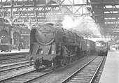 British Railways 2-10-0 Standard Class 9F No 92215 is seen at the head of an up Class E express freight service as it passes through the up through road on 29th March 1961