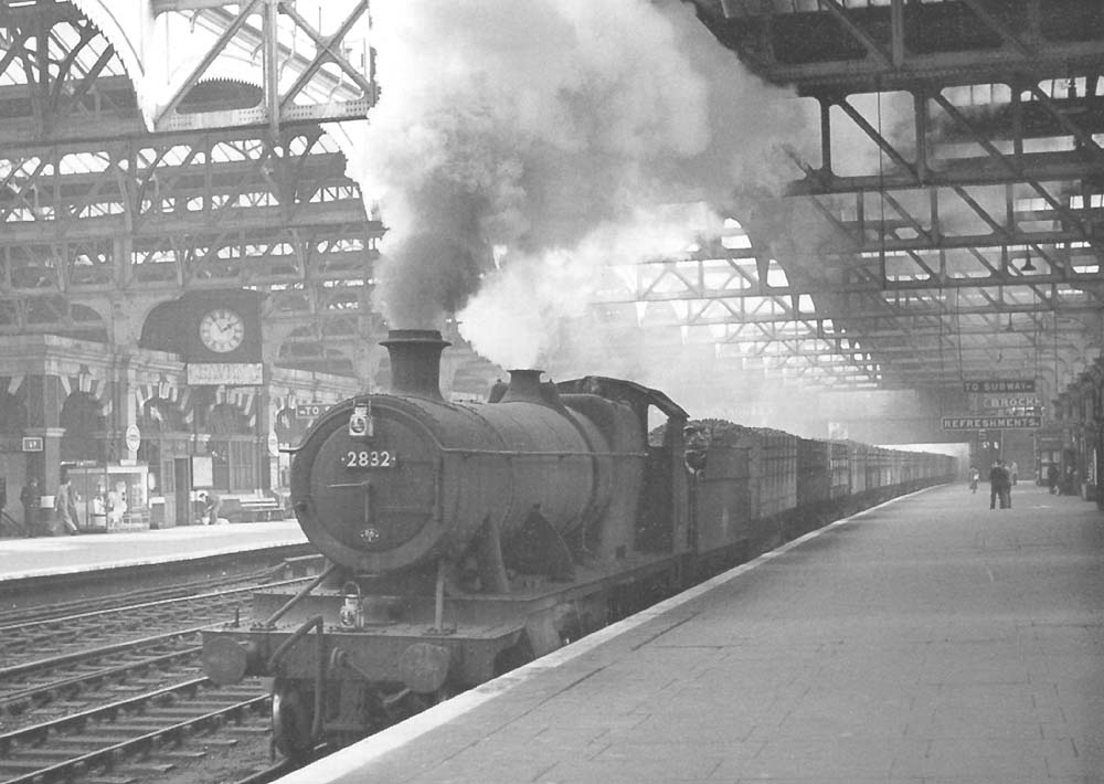 Ex-GWR 2-8-0 class 28xx No 2832 is seen passing through Snow Hill station's Platforms 5 and 6 at the head of a down train of coke wagons on 2nd April 1957