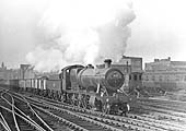 Ex-GWR 2-8-0 28xx class No 3828 is seen passing the sidings to the North of Snow Hill station whilst at the head of an up Class J train of empty mineral wagons
