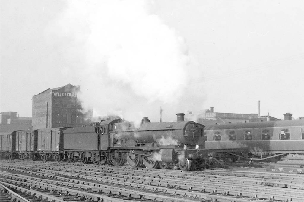 Ex-GWR 4-6-0 Grange class No 6864 'Dymock Grange' is seen leaking steam from its cylinders as it approaches Platform 12 at the head of the up 'Salop Stores' train