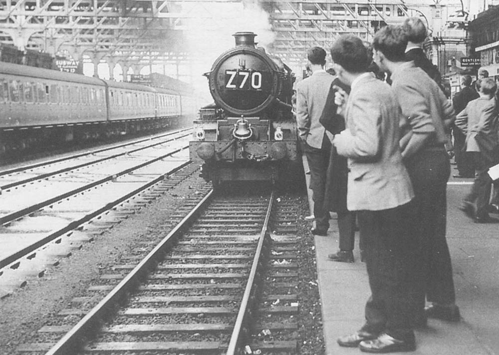 Ex-GWR 4-6-0 King class No 6000 'King George V' arrives with an up excursion to be greeted by crowds of railway enthusiasts during the final days of the reign of the GWR's Kings