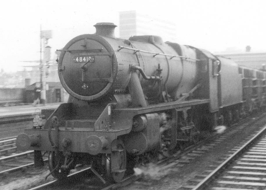 Ex-LMS 2-8-0 Class 8 No 48410 is seen passing through Snow Hill on the down through road whilst at the head of a Class J empty cement block train on 23rd October 1963