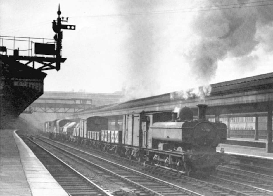 Ex-GWR 0-6-0PT 57xx class No 5738 is seen passing through Snow Hill station on an up Class X freight on Monday 14th September 1953