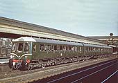 A British Railways Derby Class 116 Diesel Multiple Unit in original green livery with 'cat whiskers' is seen standing ready to leave for Great Malvern at Platform 8 in 1957