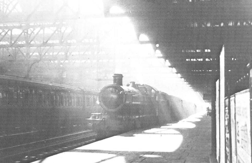 In the blazing sunshine of a holiday Saturday in August 1939, an unidentifiable Great Western Railway 49xx (Hall) class 4-6-0 waits to depart from down platform No 5