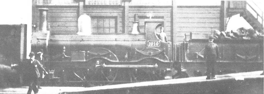 Great Western Railway '111' class 2-4-0 No 1010 stands at the end of the up side bay platforms next to the original timber framed Birmingham North Signal Box