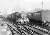 An unidentified ex-GWR 4-6-0 68xx class locomotive approaches the northern end of Snow Hill in 1953